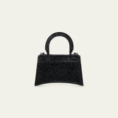 Balenciaga "Hourglass" top-handle bag in allover strass calf leather  Rolled, padded top handle Detachable, adjustable shoulder strap  Can be worn as a top handle or shoulder bag  Flap top with metal B hardware; snap closure Approx. 4.3"H x 6.7"W x 1.3"D Spot clean Made in Italy Balenciaga Hourglass Bag, Rhinestone Handbags, B Logo, Balenciaga Black, Fancy Bags, Balenciaga Bag, Moda Vintage, Mini Handbags, Studded Leather