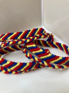 three multicolored rope on white surface