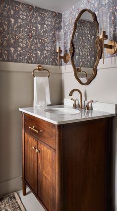 a bathroom with a sink, mirror and rug on the floor in front of it