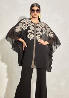 Editor's Note The black georgette floral embroidered kaftan set features a flowy kaftan with intricate floral embroidery, paired with flared pants and a matching slip. The kaftan's loose silhouette and elegant embroidery make it a perfect choice for formal occasions or evening events. Color: Black Fabric: Georgette Component: Kaftan, pant and slip Occasion: Evening wear Disclaimer: Product color may slightly vary due to photographic lighting sources or your monitor setting. Care: Dry clean only Georgette Co Ord Set, Namrata Joshipura, Kaftan Set, Cord Set, Elegant Embroidery, Trendy Fashion Tops, Boutique Dress Designs, Frill Sleeves, Bell Bottom Pants