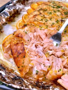 a pan filled with ham and oranges covered in seasoning next to a fork