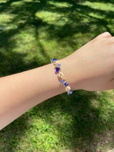 Meet our handmade Daisy Flower Bracelet in blue ombre, with an elegant gold finish. It makes a great gift for many occasions such as birthdays, anniversaries, Christmas and more! Silver finish is also available in our shop. It is an adjustable bracelet from 6 inch to 7.5 inches in length which should fit most people comfortably. If you are looking for a specific length, please message us as we would love to make it for you! This fully handmade floral-themed bracelet features intricate designs us Blue Resizable Bangle Jewelry, Blue Resizable Round Bead Jewelry, Blue Adjustable Bangle Bracelet, Blue Resizable Bangle Bracelet, Gold Flower Beaded Bracelets For Party, Gold Floral Beaded Bracelets For Parties, Gold Flower-shaped Beaded Bracelets For Parties, Resizable Blue Jewelry For Friendship, Blue Resizable Jewelry For Friendship