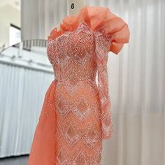 an orange dress on display in a store