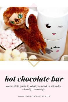 a hot chocolate bar with a stuffed animal in the middle and text that reads, hot chocolate bar