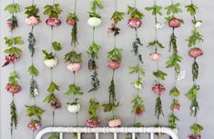 flowers are hanging on the wall next to a crib