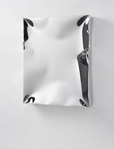 a piece of white paper hanging on the wall with black and white designs in it