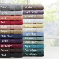 towels stacked on top of each other in various colors and sizes, with the names of different