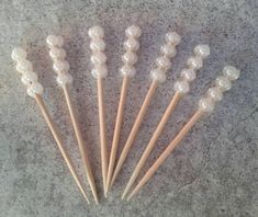 six toothpicks are lined up on the floor