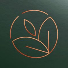 a green and orange logo with leaves in the center on a dark background that is also used as a business card