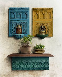 two colorful wooden shelves with pots and plants on them