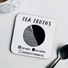 a coaster with the words tea truths on it and a spoon next to it