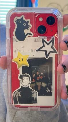 a person holding up a cell phone case with stickers on it