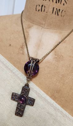 "I love this striking convertible amethyst cross necklace. The focal point of the necklace is a 3 1/2\" long pendant that is made of a large vintage brass and amethyst cabochon cross and a gorgeous large amethyst crystal set in vintage filigree. The beautiful vintage snake chain has been artfully extended so that the necklace can be worn long or short. The longest length is 27\" and the shortest is 16 1/2\". The last two pictures show that, if your neck is small, you might be able to wrap it aro Vintage Adjustable Cross Pendant Necklace, Adjustable Vintage Cross Pendant Necklace, Spiritual Cross-shaped Gemstone Necklace, Spiritual Cross Shaped Gemstone Necklace, Vintage Adjustable Crucifix Jewelry, Antique Cross Necklace For Gift, Purple Amethyst Cross Jewelry, Purple Amethyst Cross Necklace, Antique Cross Necklace For Jewelry Making