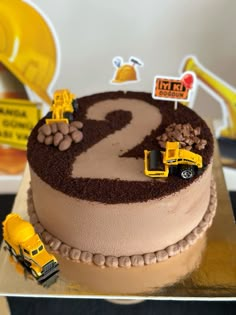 a birthday cake with construction vehicles on it