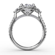 a white gold engagement ring with an oval shaped center stone surrounded by small round diamonds