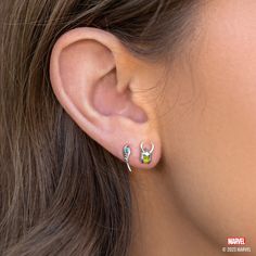 Ready to cause some mischief and chaos across the realms? Look no further than our Marvel's Loki Studs. Featuring a striking green silhouette of the God of Mischief in his signature horned helmet and holding his mystical scepter, complete with a vibrant blue accent. Get ready to channel your inner Loki and add a touch of rebellious style to your outfit with this one-of-a-kind set. Panther Earrings, Black Panther Necklace, Avengers Icon, Green Silhouette, Horned Helmet, Marvel Jewelry, God Of Mischief, Rose Gold And Silver, Wakanda Forever