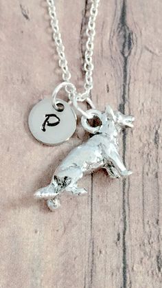 "This listing is for a hand-stamped initial necklace featuring a 1/2\" x 3/4\" silver plated pewter German Shepherd charm & 2/5\" stainless steel initial pendant. The silver plated chain is 18\" long, but can be made to your desired length- see last photo in listing for length guide. Please indicate the chain length you would like in the 'notes to seller' section at checkout. All items are lead & nickel free. Message me with any questions, thank you! Add an initial to any necklace https: Sterling Silver Dog Tag Necklace With Charms, Silver Dog Tag Jewelry With Charms, Hypoallergenic Sterling Silver Dog Tag Jewelry, Silver Hypoallergenic Dog Tag Jewelry, Hypoallergenic Silver Dog Tag Jewelry, Stamped Stainless Steel Silver Necklace, Adjustable Engraved Silver Charm Necklaces, Personalized Sterling Silver Dog Tag Jewelry, Nickel-free Dog Tag Jewelry For Personalized Gifts