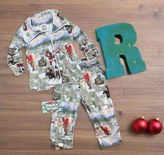 Here's our bestselling Kids Cowboy Santa Christmas Pjs! These button-down Christmas pajamas are Perfect Christmas Morning pajamas for you, your little's, and the whole family! It's a Western Christmas! Yeehaw! Razels' Exclusive PJs are high-quality, well-made pajama sets that are perfect for this Holiday Season! The pictures do not do this one justice! A fun print of old Saint Nick himself with a few of his best horses! This set will become a favorite for the Western at heart, young and old alik Family Christmas Pjs, Matching Family Christmas Pjs, Adult Christmas Pajamas, Cowboy Santa, Christmas Pjs Family, Family Pjs, Cowgirl Dresses, Unisex Pajamas, Saint Nick