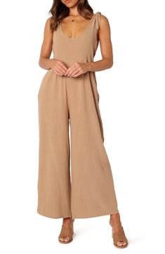 Elevate your contemporary wardrobe with this tie-shoulder linen jumpsuit finished with wide legs and handy side pockets. Pull-on style Adjustable tie straps Side-seam pockets Unlined 100% linen Hand wash, dry flat Imported Linen Jumpsuit For The Beach, Beige Linen Overall Jumpsuits And Rompers, Beige Linen Overalls Jumpsuit, Wide Leg Overalls For Summer, Linen Jumpsuits And Rompers For Summer, Solid Color Linen Jumpsuits And Rompers For Summer, Chic Beige Linen Jumpsuits And Rompers, Beige Linen Overalls, Chic Brown Jumpsuits And Rompers For Summer