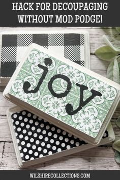 two coasters with the words joy on them and an image of a plant in the background