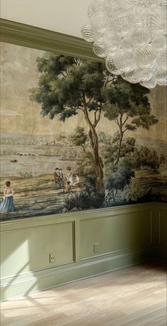 a room with a painting on the wall next to a chandelier