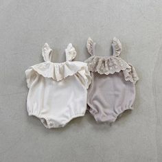 Casual Beige Cotton Bodysuit, White Cotton Jumpsuits And Rompers For Beach, White Cotton Beach Jumpsuits And Rompers, Cute Bodysuit For Summer, Cute Solid Color Summer Bodysuit, Cute Solid Color Bodysuit For Summer, Summer Cotton Bodysuit For Playwear, Cotton Jumpsuits And Rompers With Ruffles, Cotton Onesie For Spring