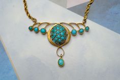 "STORY --------- Crafted in 9 carat gold, this vintage Art Nouveau style necklace features a pretty organic floral pendant section inset with natural green & blue turquoise, and is fastened with a gold rope twist chain and bolt ring. Despite some age related wear, it remains wearable today... SPECIFICS -------------- Metal: 9 carat gold (tested, hallmark illegible) Stones: Turquoise Dimensions: 15.5\" long Condition Notes & Care: Overall in expected vintage condition with some minor denting, wea Turquoise Vintage Jewelry With Vintage Charm, Vintage Yellow Gold Cabochon Necklace, Hallmarked Oval Turquoise Necklace, Heirloom Turquoise Necklace As Gift, Heirloom Turquoise Necklace For Gift, Victorian Turquoise Pendant Jewelry, Victorian Turquoise Necklace For Wedding, Antique Turquoise Pendant Necklace, Victorian Turquoise Gemstone Jewelry