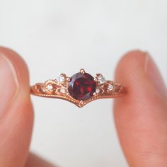 If you are a lover of all things vintage then a vintage-inspired ring is the ring for you. With a deep color of Black Spinel and the delicate migraine and filigree our Lorna ring with accented Moissanite, is definitely a unique and one-of-a-kind statement ring. Details: Center gemstone: Garnet Stone Shape: Round Measurements: approx. 5mm Total carat weight: 0.5 carat Side ring stones: Moissanite Measurements: approx, 1.5mm, 1.1mm Band measurements: approx. 1.8mm wide, approx. 1.5mm thick Picture Garnet Stone Ring, Ring Stones, Vintage Inspired Rings, Moss Agate Ring, Blue Topaz Stone, Rose Quartz Ring, Garnet Stone, Swiss Blue Topaz, Agate Ring