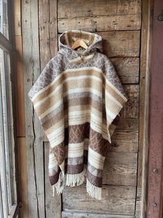 Alpaca/lambswool mix poncho hooded Brown lambswool/alpaca wool poncho Etno style wool poncho very warm and breathable Blanket poncho One size fits fashionably for most everyone, short or tall, big or small. This piece is versatile for both Men's & Women's outdoor fashion, and can be used insider in cooler winter weather to keep warm while reading on the couch. CARE: Hand-wash and hang to dry, light iron if needed, or dry clean. MEASURES: Length at the front of the neckline to the bottom is ~100 Bohemian Wool Poncho In Cape Style, Bohemian Wool Poncho Cape, Cozy Brown Alpaca Poncho, Handwoven Brown Poncho For Winter, Handwoven Wool Poncho For Fall, Brown One Size Poncho With Fringe, One Size Brown Fringe Poncho, Brown Fringe One Size Poncho, Traditional Beige Poncho For Winter