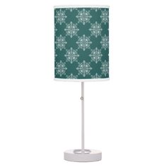 a green and white lamp with snowflakes on the lampshade is shown