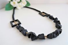 One-of-a-kind black onyx necklace. This raw onyx bead necklace is a stunning black statement necklace design. Wear this beautiful black and gold necklace with any color, day or night. Measurements - 30 Inch  (76 cm) All the jewelry in my shop is designed with love and handmade by me. They are packed carefully in a gift box. See more necklaces in my shop   https://www.etsy.com/il-en/shop/TsilaAxelrod?ref=hdr_shop_menu Thank you for visiting my shop.  Have a nice day! Black And Gold Necklace, Beaded Necklace Black, Black Beaded Necklace, Black Onyx Necklace, Black Bead Necklace, Onyx Necklace, Onyx Bead, Necklace Black, Black Beads