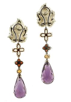 Marvelous dangle earrings realized in 14k white and rose gold structure, with a mother-of-pearl flower in the upper part, little flowers made of multicolor sapphires and diamonds in the middle and two drops of hydrothermal amethyst as pendant. The origin of this pair of earrings goes back to the 1960s, they were made in Italy by Italian master goldsmiths and they are in perfect condition now. Diamonds 0.05 ct Multicolor sapphires 3.65 ct Mother-of-pearl and hydrothermal amethyst 6.20 g Total wei Gold Reserve, White Stones, Pearl And Diamond Earrings, Vintage Pearls, Pearl Flower, Pearl Diamond, Little Flowers, Gold Earrings Dangle, Yellow Sapphire