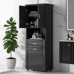 a bathroom with a black cabinet and white counter top next to a potted plant