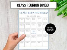 a close up of a person's hand holding a class reunion bingo