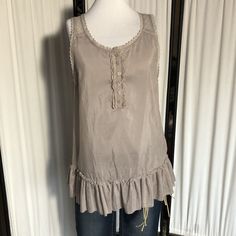 Nwot Grey Sleeveless Boho Lace Tank Top With Ruffles And A Lot Of Details On Front And Back. New Without Tag, Never Worn. Now It's Too Small For Me And I Was Hoping A Size L Would Fit. The Risk Of Having A Larger Chest And Buying Without Asking For Measurements. Length: 28 Inches Pit To Pit: 19 Inches Stretchy: No Content: Cotton And Silk Thanks For Checking! Ask With Any Questions, Happy Poshing. Search Tags: Silk Bohemian Romantic Ruffle Button Large Size L Summer Breezy Casual Cami Tank Top With Ruffle Hem, Spring Camisole Top With Ruffle Hem, Summer Tank Top With Ruffled Hem And Straps, Summer Ruffle Hem Tank Top, Spring Ruffle Hem Camisole Top, Casual Sleeveless Tank Top With Ruffle Hem, Sleeveless Bohemian Top With Ruffle Hem, Bohemian Sleeveless Top With Ruffle Hem, Spring Ruffle Hem Cami Top