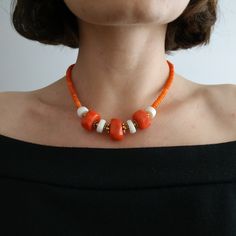 < Orange and white coral beaded necklace > This product made according to the model of authentic traditional Ukrainian jewelry. The coral is modern, the design is vintage. Like 99% of the coral on the market these days, this coral has been dyed. I use bamboo coral which is not endangered or threatened in any way, unlike natural pink or red coral (the production of which is forbidden almost everywhere in the world). Bamboo coral doesn't mean it's not organic. Every bead of it has a distinct Orange Red Coral Beaded Necklaces With Large Beads, Orange Red Coral Beaded Necklace With Large Beads, Orange Polished Beads Necklace, Orange Beaded Necklace With Large Red Coral Beads, Coral Beaded Necklaces With Large Beads, Artisan White Beaded Necklace, Elegant Orange Beaded Necklace With Wooden Beads, Handmade Coral Beads, Orange Beaded Necklaces With Wooden Beads For Gifts