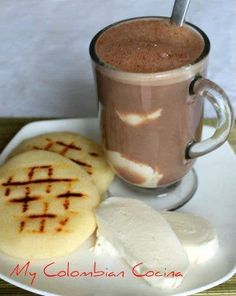 a cup of coffee and some cookies on a plate