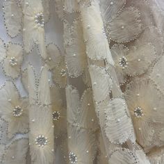 Make a statement with amazing, beaded 3D lace fabric! This luxurious fabric is perfect for creating high-end pieces for any special occasion. Our exquisite 100% polyester net mesh is intricately embroidered with a beautiful, beaded 3D floral design, making it a stunning choice for couture 3D bridal lace, evening dress 3D lace, quinceanera dress 3D lace, dance costume 3D lace and any other fabulous special occasion piece. Perfect for adding a couture touch to your look, this beaded 3D lace fabric Floral Lace Fabric, Beaded Lace Fabric, Quinceanera Dress, Luxurious Fabric, Dance Costume, Quinceanera Dresses, Bridal Lace, Beaded Lace, Luxury Fabrics