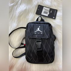 Nike Jordan Small Crossbody Bag Anti-Gravity Pouch (One Size, Black) Details Materials Composition 100% Polyester: A Very Strong Synthetic Fiber That Boasts High Heat Resistance And Excellent Odor Absorption Care Instructions Hand Wash Details Colour: Black Fastening: Zip Fastening Details: Embroidery On The Front Outer Pockets: 2 Backpack Handle: Yes Size: 16 X 10 X 4 Cm Capacity: Universal Brand: Jordan Reference: 9a0438-023 Functional Black Crossbody Phone Bag, Black Nylon Phone Bag For Daily Use, Black Nylon Phone Bag For Everyday Use, Black Mobile Phone Shoulder Bag For Streetwear, Functional Black Pouch Phone Bag, Functional Black Phone Pouch Bag, Black Crossbody Mobile Phone Pouch, Black Nylon Bag With Cell Phone Pocket, Black Nylon Bags With Cell Phone Pocket