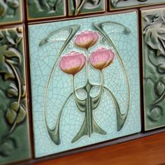 some tiles with pink flowers on them