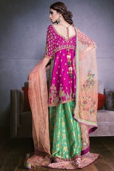 Elegant Indian mehndi lehnga dress in pink and green color with peach color dupatta. Beautiful lehnga style Indian mehndi dress is fully embroidered with golden threads, pearls, dabka, gotta and embroidered patches. Top: Front and back is fully embellished with hand made embroidery. Top blouse in shocking pink color is nicely embroidered with dabka, gotta, zari and stones. Dupatta: Peach color dupatta is added with beautiful Indian mehndi lehnga dress to enhance its grace and beauty. Dupatta is Mehndi Lehnga, Lehnga Style, Designer Mehndi, Indian Mehndi, Mehndi Dress, Beautiful Bridal Dresses, Desi Love, Lehnga Dress, Bridal Dress Design