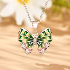 Add sparkle to your look with this butterfly-inspired necklace. Beautiful enamel design with vibrant colours and wings that'll define the Spirit of You. This intricate design is handcrafted using the legendary art of enameling, with sparkling stones that recreate the charm of the butterfly. Inspired by the beauty of nature, this will brighten up even the dullest of days in your life. Vibrant and full of life, this beautiful butterfly is ready to land in your jewelry box.Carat Weight: 0.479 ctSto Multicolor Butterfly Charm Necklaces, Multicolor Butterfly Charm Jewelry, Green Butterfly Charm Necklace, Elegant Multicolor Butterfly Charm Jewelry, Multicolor Butterfly Jewelry Gift, Multicolor Butterfly Jewelry For Gifts, Green Butterfly Jewelry For Gifts, Green Butterfly Charm Pendant Necklace, Elegant Multicolor Jewelry With Butterfly Charm