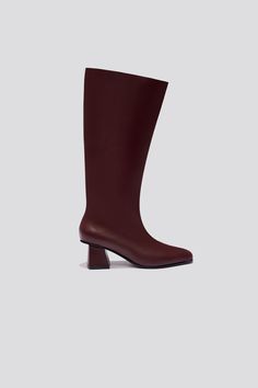 The Caro is a stylish block-heeled boot with a 2-inch offset heel and an elongated square toe. Its tall, wide 16-inch shaft has a 17.25-inch circumference, making it comfortable for wider calves and offering a loose fit for slim calves—ideal for tucking in pants. Made from flexible, structured leather, the Caro boot combines fashion with function, providing ease of fit and a very walkable heel. It's versatile enough to style with skirts, dresses, and shorts, offering a creative yet practical col Knee-high Boots With Reinforced Heel And Square Toe, Wide Calf Heeled Boots With Sculpted Block Heel, Wide Calf Boots With Sculpted Heel And Square Toe, Wide Calf Boots With Padded Heel And Square Toe, Wide Calf Low Heel Boots With Reinforced Heel, Modern Knee-high Boots With Sculpted Heel And Square Toe, Slim Calves, Loafer Mules, Wide Calf