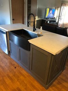 a kitchen with an island and sink in it