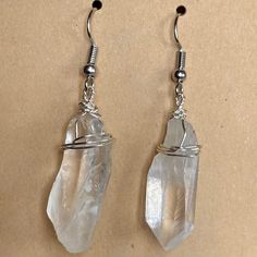 Clear Quartz is a healing crystal, absorbing and regulating positive energy and dispelling negative energy. It provides spiritual and emotional harmony and balance. Like all of my earrings, these are made with nickel-free hooks. The wire wrapping is made of silver-plated copper. White Wire Wrapped Drop Earrings, Minimalist Wire Wrapped Crystal Earrings As Gift, Minimalist Wire Wrapped Crystal Dangle Earrings, White Wire Wrapped Dangle Crystal Earrings, White Wire Wrapped Drop Crystal Earrings, Minimalist Wire Wrapped Crystal Drop Earrings, Gift Crystal Earrings With Clear Ear Wire, Gift Clear Crystal Earrings With Ear Wire, Adjustable Silver Wire Wrapped Crystal Earrings