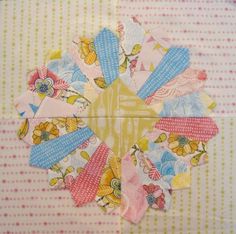 a close up of a piece of fabric on a table cloth with flowers and stripes