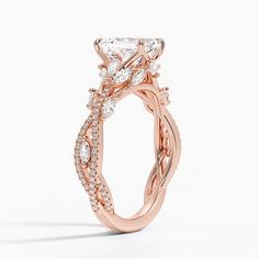 a rose gold engagement ring with an intricate design and round brilliant cut diamonds on the band