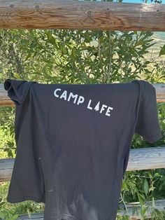 Camp Life screen printed graphic tee made on a comfort colors T-shirt choose from black or cumin red color unisex, fits a little oversized colors may differ in person Black T-shirt With Letter Print For Outdoor, Black Letter Print Tops For Camping, Black Cotton T-shirt For Outdoor, Black Short Sleeve Top For Camping, Black Graphic Tee For Camping, Black Crew Neck T-shirt For Camping, Graphic Tee With Text Print For Camping, Black Graphic Print T-shirt For Camping, Casual Black Tops For Camping