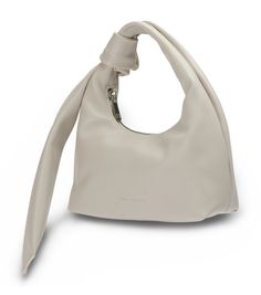 Introducing Elsa, our super soft, buttery smooth, white leather handbag. Balancing cool-girl chicness and practicality, this hand held bag is the perfect size for your next night out featuring a fold over knot detail, silver hardware, internal pocket and zip closure. -Material: Canvas/Leather -Features: Internal Pockets -Opening: Zip Closure -Strap Drop: 16cm -Body Measurements: 13cm Height x 21cm Width x 9cm Depth