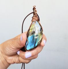 A beautiful colorful Labradorite wire wrapped with a sturdy tarnish free copper wire. This lovely pendant has a simple style wrap and the stone has some pretty tones of blue, green, yellow and purple. I wrap all of my jewelry with a sturdy tarnish free wire. Please view all of the photos for details and choose your chain length at checkout. All jewelry will come in a jewelry box or bag perfect to give as a gift. Need a personalized note? Let me know what you would like it to say. Buy more then o Wire Wrap Pendant, Christmas Gift Jewelry, Purple Stones, Labradorite Pendant, Gift Jewelry, Wire Wrapped Pendant, Jewelry For Women, Wire Wrap, Copper Wire